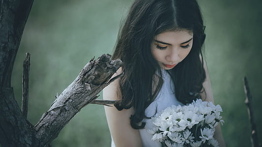 Woman Wearing White Halter Top Holding White Flower Bouquet thumbnail