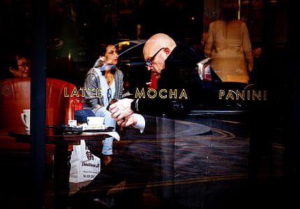 man sitting inside cafe store thumbnail