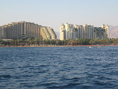 two white-painted buildings in front of beach shore thumbnail