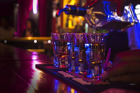 person pouring liquor on glasses thumbnail