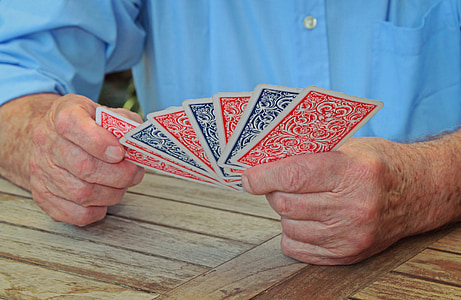 person holding playing cards thumbnail