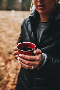 person holding red ceramic mug thumbnail