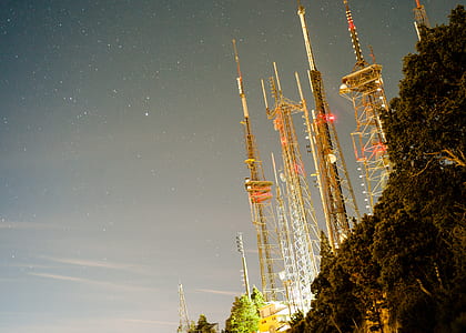 assorted towers near a cliff during night time thumbnail