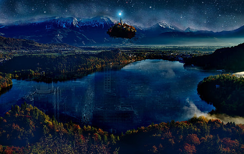 body of water near mountain under starry night thumbnail