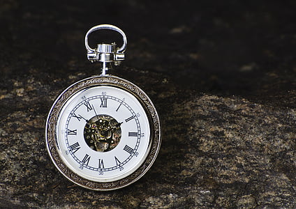 selective focus photography of silver-colored pocket watch thumbnail