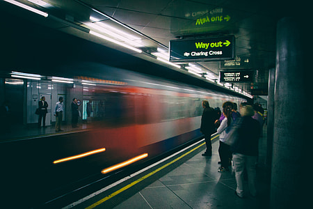 A train arrives for the waiting passengers on the platform of the London Underground network thumbnail