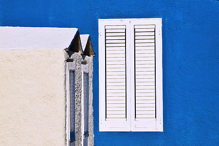 white wooden window on blue building thumbnail