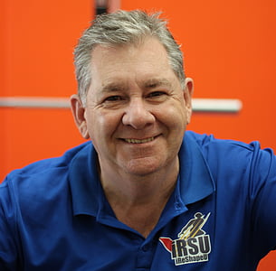 smiling man in blue shirt thumbnail