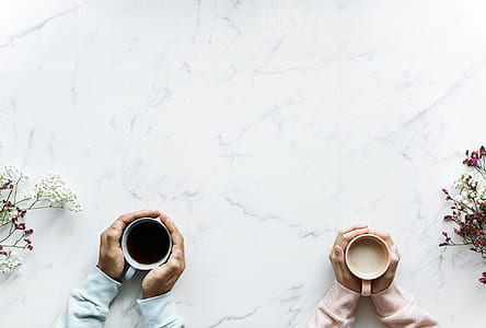 top view of two person feeling coffee cup warmth thumbnail
