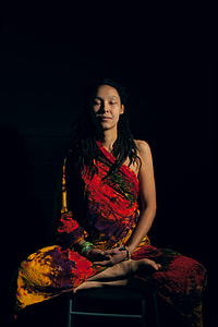woman sitting on chair with black background thumbnail