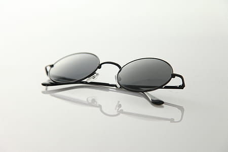 Black Frame Sunglasses on White Surface thumbnail