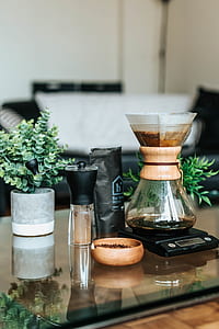 brewed coffee on scale beside grinder on table thumbnail