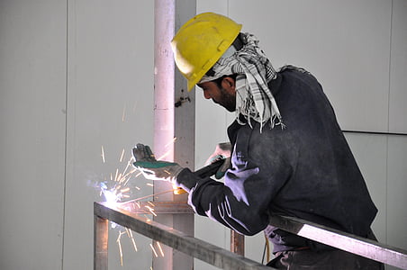 man constructing metal frame with welding machine thumbnail