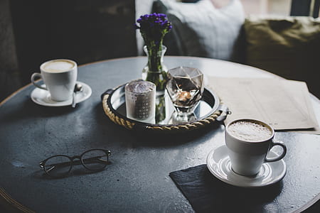 two white ceramic cups on saucers thumbnail