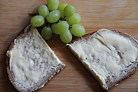 flat bread and green grapes on brown wooden surface thumbnail