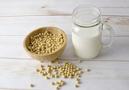 milk filled clear glass jar mug beside brown bowl thumbnail