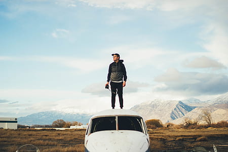 man standing top of abandoned airplane at daytime thumbnail