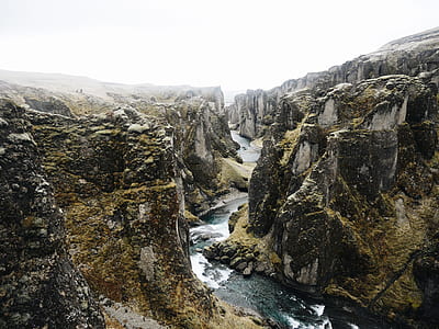 photography of river surrounded by mountains during daytime thumbnail