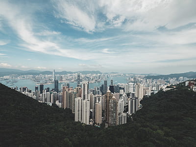aerial photography of high-rise buildings near body of water under white cloudy sky thumbnail
