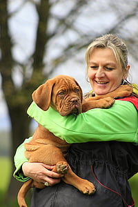 woman carrying French mastiff puppy thumbnail
