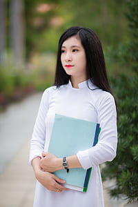 woman holding books thumbnail