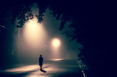 person standing under street light at light thumbnail