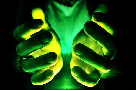 selective color photography of person's hand with green lights thumbnail