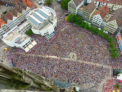 crown of people standing beside white high-rise building thumbnail