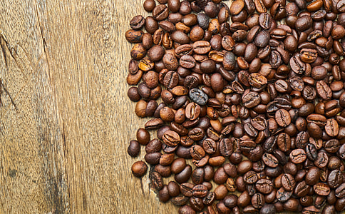 roasted coffee beans on brown wooden surface thumbnail