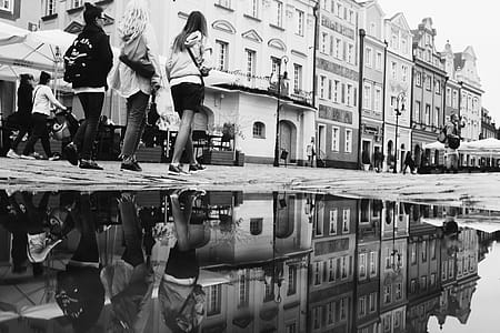 Grayscale Photo of Group of People Walking Near Building thumbnail