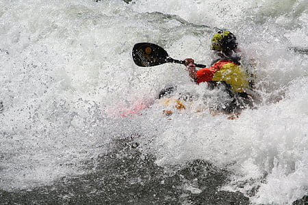 photo of person riding on boat holding paddle thumbnail