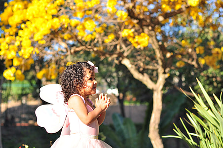 girl standing near linear leaf green plant during daytime thumbnail