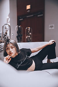 woman lying on grey sofa thumbnail