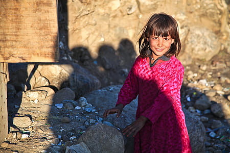 girl wearing pink dress near rocks thumbnail