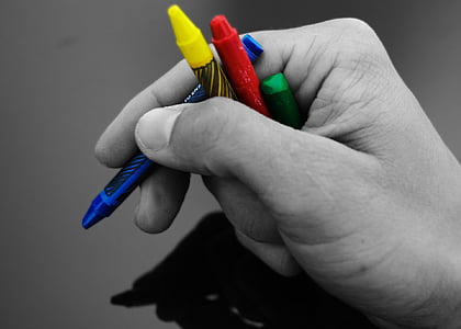 person holding crayons thumbnail