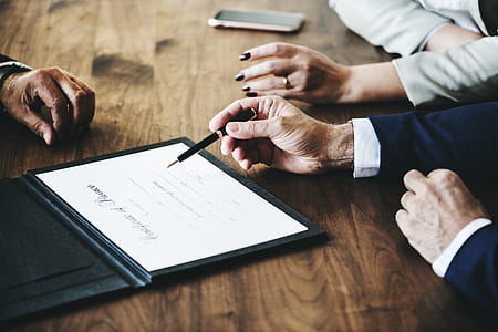 man holding pen while trying to sign a document thumbnail