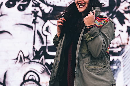 woman holding button-up coat thumbnail