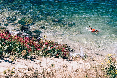 Person Swimming on the Beach Photography thumbnail