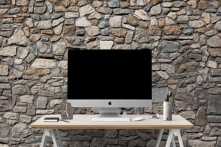 silver iMac on top of white wooden table thumbnail