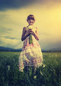 smiling girl holding white flower bouquet thumbnail