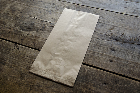 brown paper bag on wooden surface thumbnail
