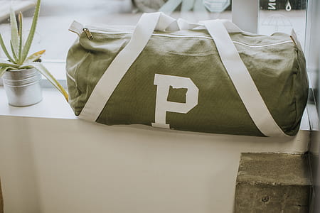 black and green duffle bag on window thumbnail
