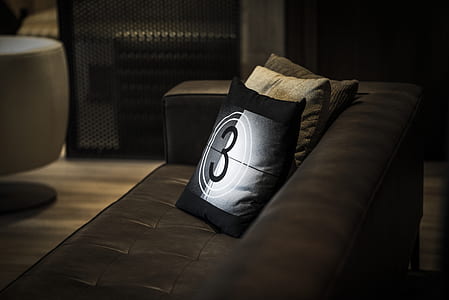 three assorted-color throw pillows on tufted sofa thumbnail