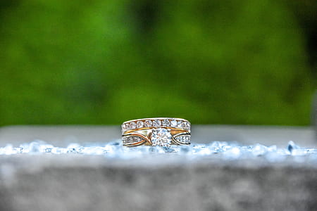 shallow focus photography of ring studded with clear gemstones thumbnail