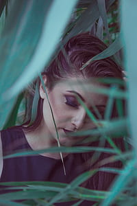 woman wearing black top surrounded with grass thumbnail