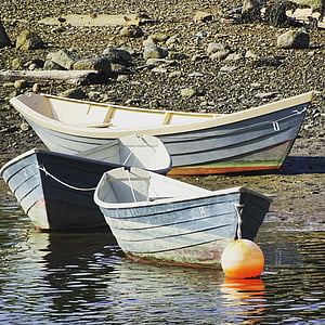 three gray boats on shore thumbnail