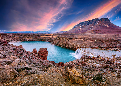 gray and brown rock formation near body of water photography thumbnail