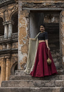 Woman In Red And Black Dress Posing For A Photo thumbnail