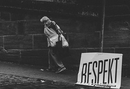 person walking in the street while holding white plastic bag thumbnail