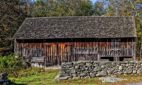 brown wooden house near pile of stones thumbnail